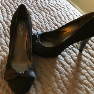 Black suede pumps with satin bow.